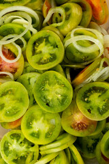 Freshly sliced green tomato, ready to make a salad. Photo taken in natural, soft light.