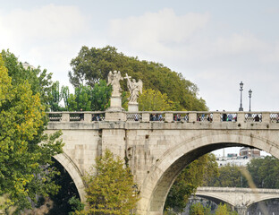 A view of the Saint Angelo bridge during the fall spanning the Tiber river in Rome Italy.