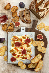 Butter board topped with fresh figs, fig jam, spicy paprika jelly and chili threads. Trend food