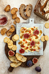 Butter board topped with fresh figs, fig jam, spicy paprika jelly and chili threads. Trend food