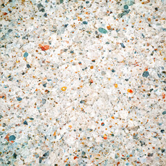 Stone texture. Vector illustration. Cut of white stone interspersed with colored gems - orange and blue. Repeating texture of white rough surface.