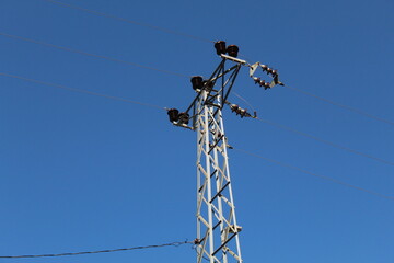An electric pole with blue background