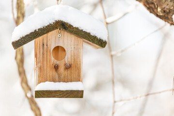 Closeup of empty bird house in snow