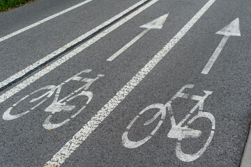 White bicycle lane sign. Bicycle lines in the city, park.