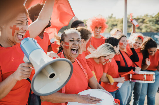 Multiracial group of sports fans celebrate their team victory