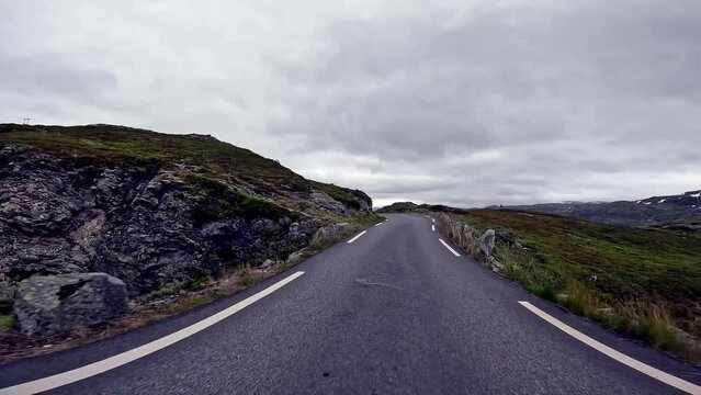 First person view of a road through norwegian mountains, gloomy, Norway