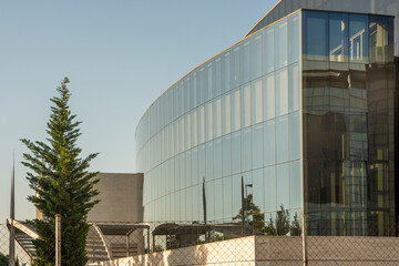 facade of office buildings with lots of dark glass and meta on a day with pristine skies