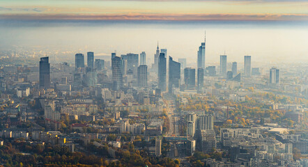 Stunning aerial view of downtown Warsaw from plane window. Autumn morning. Sunrise with fog over the city. Modern skyscrapers. High quality photo - obrazy, fototapety, plakaty