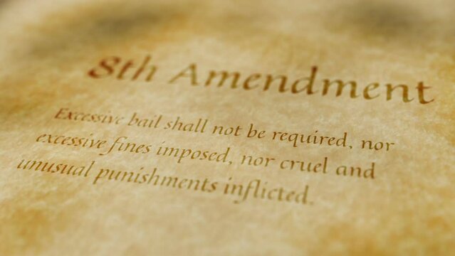 Scrolling text on an old paper background of the contents of the 8th amendment to the United States Constitution that guarantees the prohibition of cruel and unusual punishment.