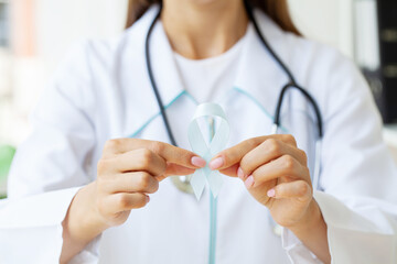 Brain Cancer Awareness month, woman hand holding white color Ribbon