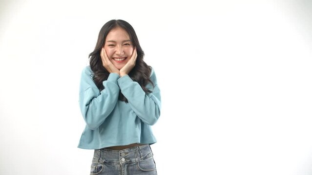 Excited Asian young woman surprise lucky on white background. Positive joyful girl wear casual jean expressive  stunning wow raise up hands looking at copy space over isolated. Win success fun concept