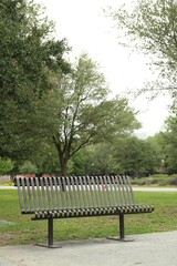 Fototapeta premium Stylish metal bench in park on sunny day