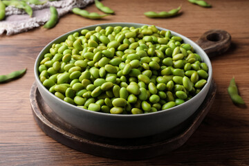 Bowl of delicious edamame beans on wooden table
