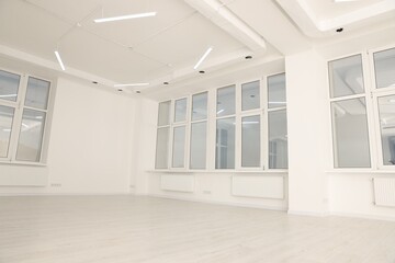 Modern office room with white walls and windows. Interior design