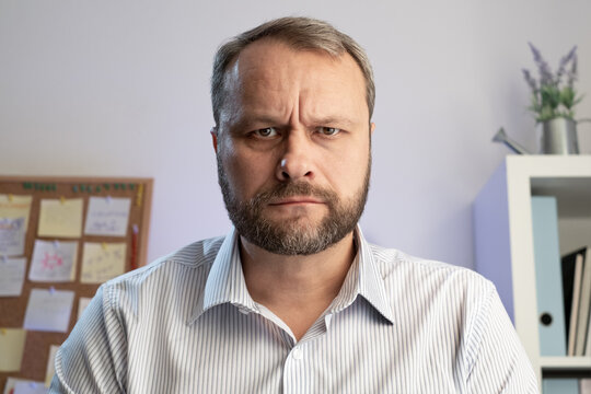 Serious Angry Middle Aged Man. Make Online Calls And Live Video Conference Chat Using A Computer. Home Office Close Up Webcam View, Online VideoChat Concept