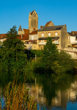 Marne river, residential buildings and local church along riverside in Dormans. Marne department, Grand Est region of France.