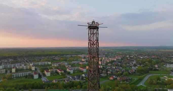 Aerial view of the wooden broadcasting tower in Gliwice with the city of Gliwice in the background. The concept of the largest wooden tower in the world. Wooden construction from a drone.