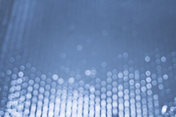 Abstract background with bokeh effect. Blurred defocused lights in blue colors. The bokeh on the...