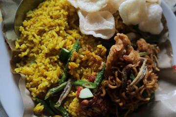 Nasi kuning on food paper, Nasi kuning is one of the foods from Indonesia