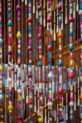 Fragment of a curtain of a plastic beads. Old wooden curtain of beads in the kitchen.