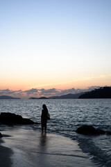 Woman on the beach at sunset