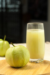 Guava smoothie in a glass and fresh guava