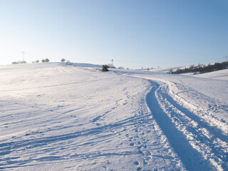 Fototapeta na wymiar Road in a snowy field