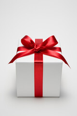 Obraz premium Gift box decorated with red ribbon.