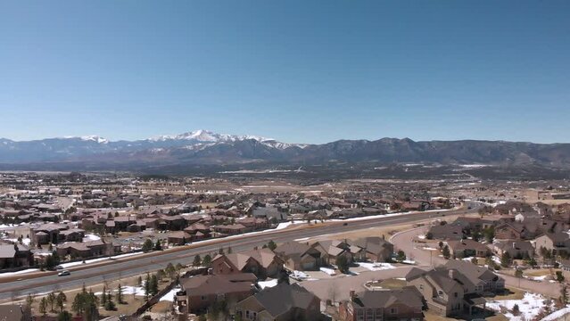 Cars Driving on Road in Colorado Foothills near the Rocky Mountains • Ascending Aerial Drone Shot • Horizontal HD Footage