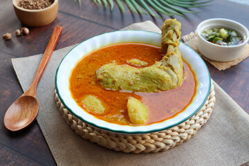 Chicken curry with potato and cucumber dips - Traditional Thai food called Kang Kari Gai at close up view