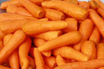 Peeled carrots are stacked together.