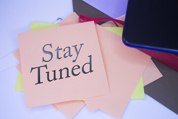 Stay Tuned. Text on adhesive note paper. Event, celebration reminder message.