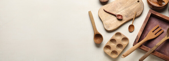 Fototapeta Wooden cooking utensils on light background with space for text, top view obraz