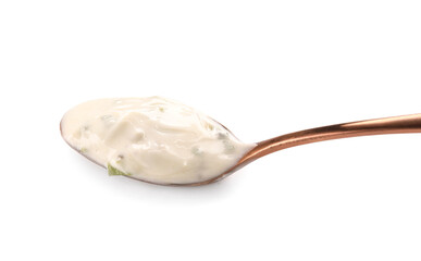 Spoon with Caesar salad sauce on white background