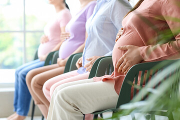 Young pregnant women at course for expectant mothers, closeup