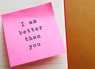 Pink note on envelope background with handwritten text SUPERIORITY COMPLEX, means belief that your abilities or accomplishments are dramatically better than someone else - obrazy, fototapety, plakaty