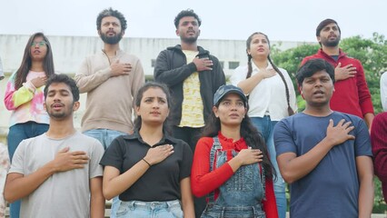 pan shot of audience praying for singing national anthem stadium before match - concept of championship, patriotism and togetherness.