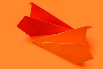 Paper planes on red background, closeup