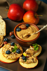 Plate of fresh apples with nut butter and blueberry, closeup