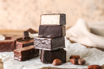 Stack of tasty bird's milk candies on wooden table