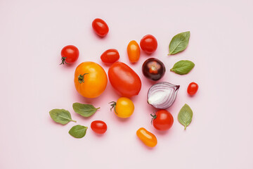 Composition with fresh ripe tomatoes on pink background
