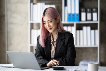 Fototapeta premium Happy successful businesswoman relaxing in her chair at the office with a big smile