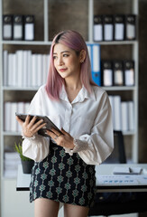 Fototapeta premium Young beautiful woman working in the office. Relaxing in office