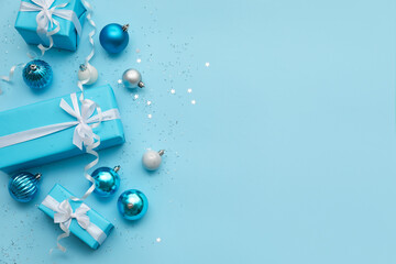 Composition with Christmas gifts, balls and serpentine on color background