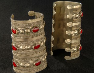 Antique bracelets with engraving and precious stones isolated on a black background