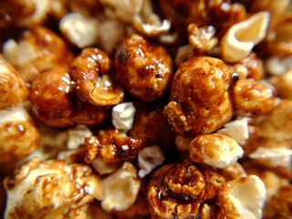 A handful of sweet popcorn with caramel close-up