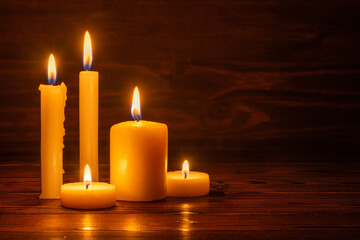 burning candles on wooden background, room interior, copy space