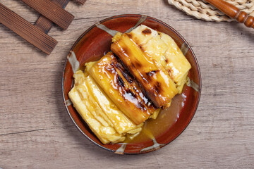 Grilled cassava topped with sweet coconut milk. Thai dessert.