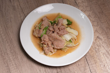 Stir Fried Cabbage with Pork in a White Plate