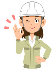 OKのサインを出すヘルメットを被った作業着の女性
